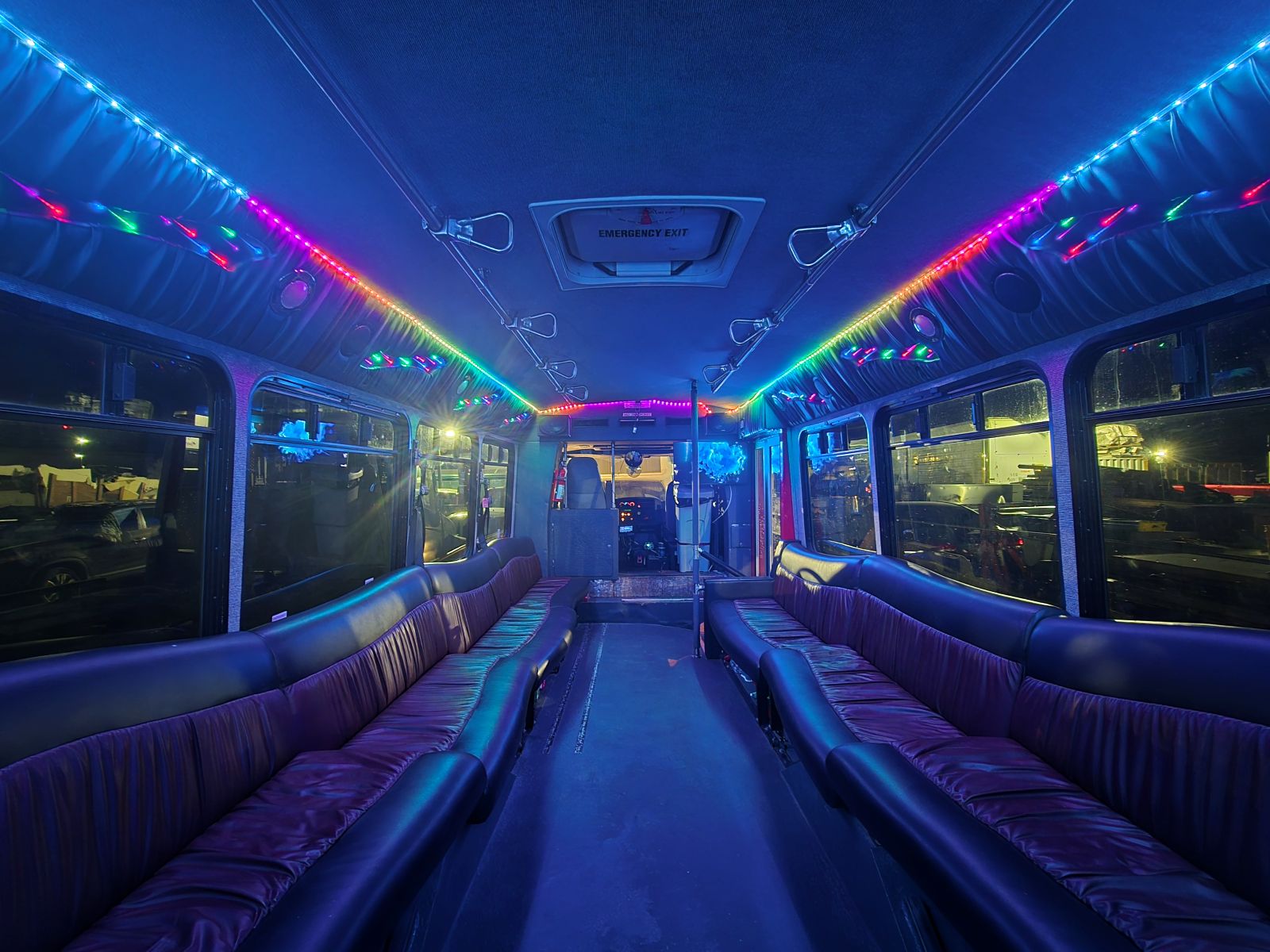 multi-colored lights inside a limo bus at night