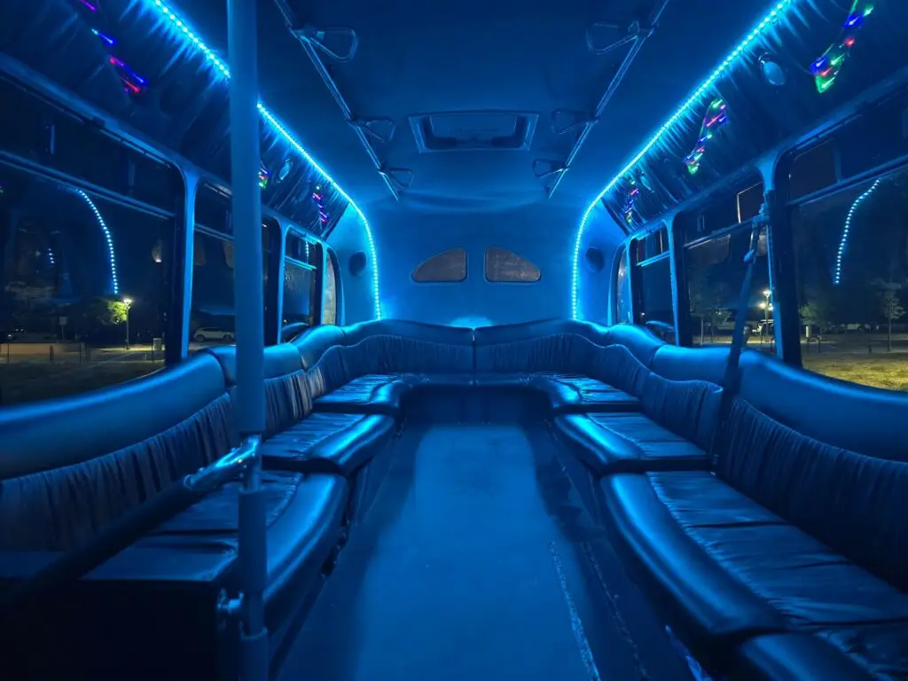 Blue lights illuminating interior of limo bus at night