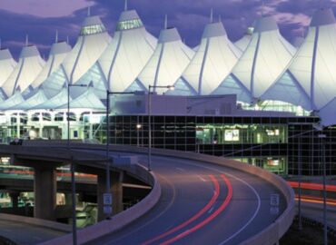 road leading into Denver International Airport lit up at dusk
