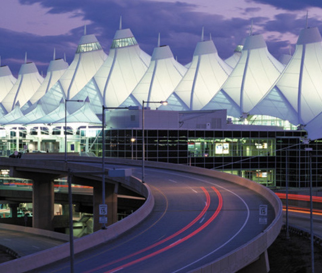 road leading into Denver International Airport lit up at dusk