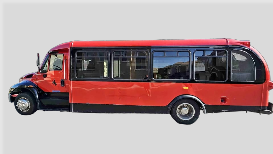 Side view of red and black limo party bus
