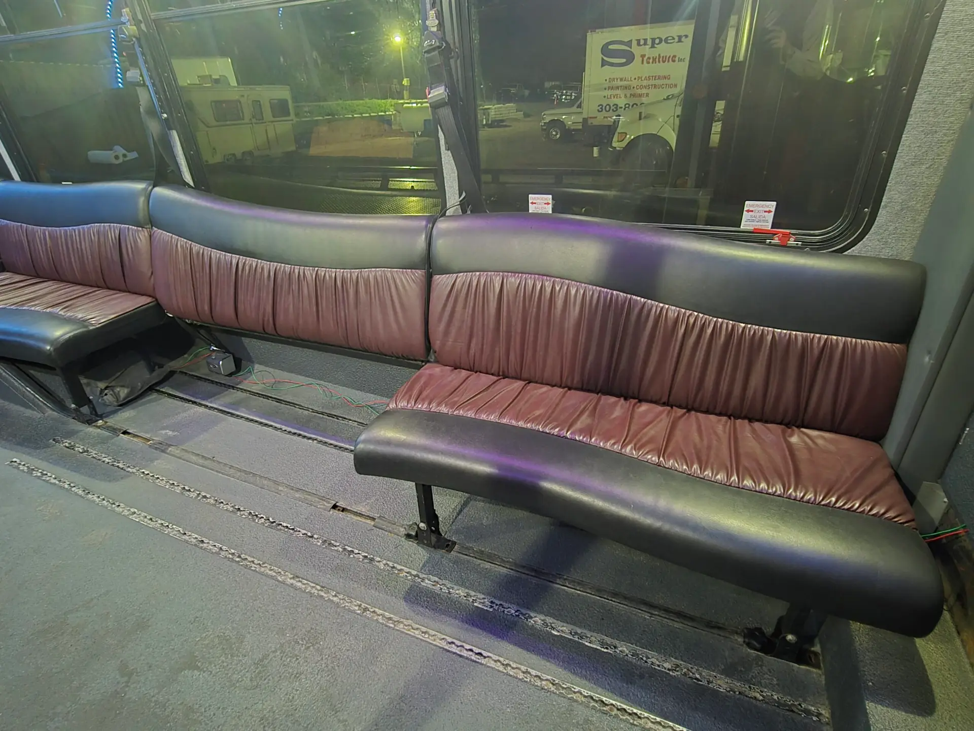 One black and brown limo seat section removed with space for one wheelchair
