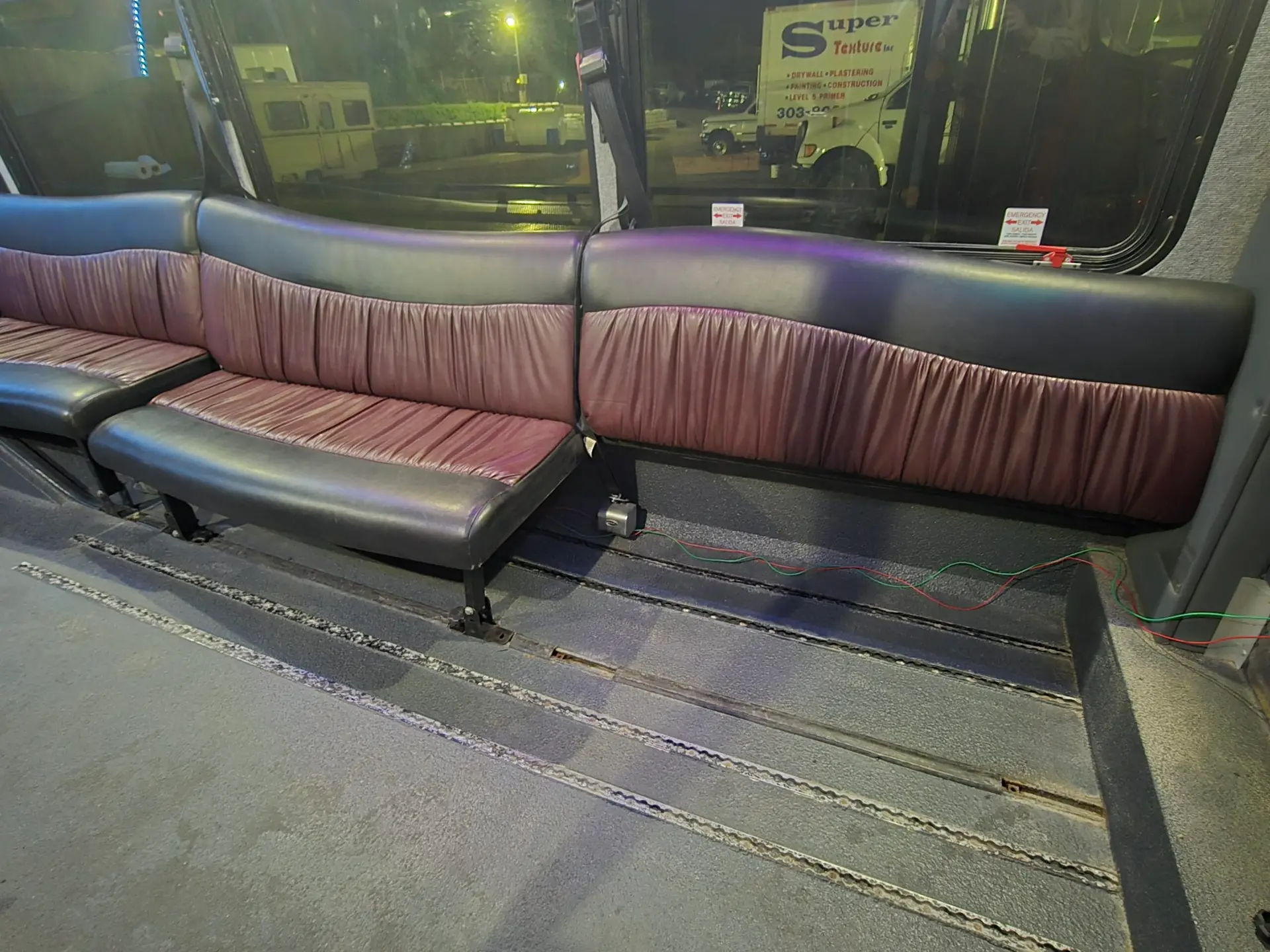 One black and brown limo seat section and space for one wheelchair